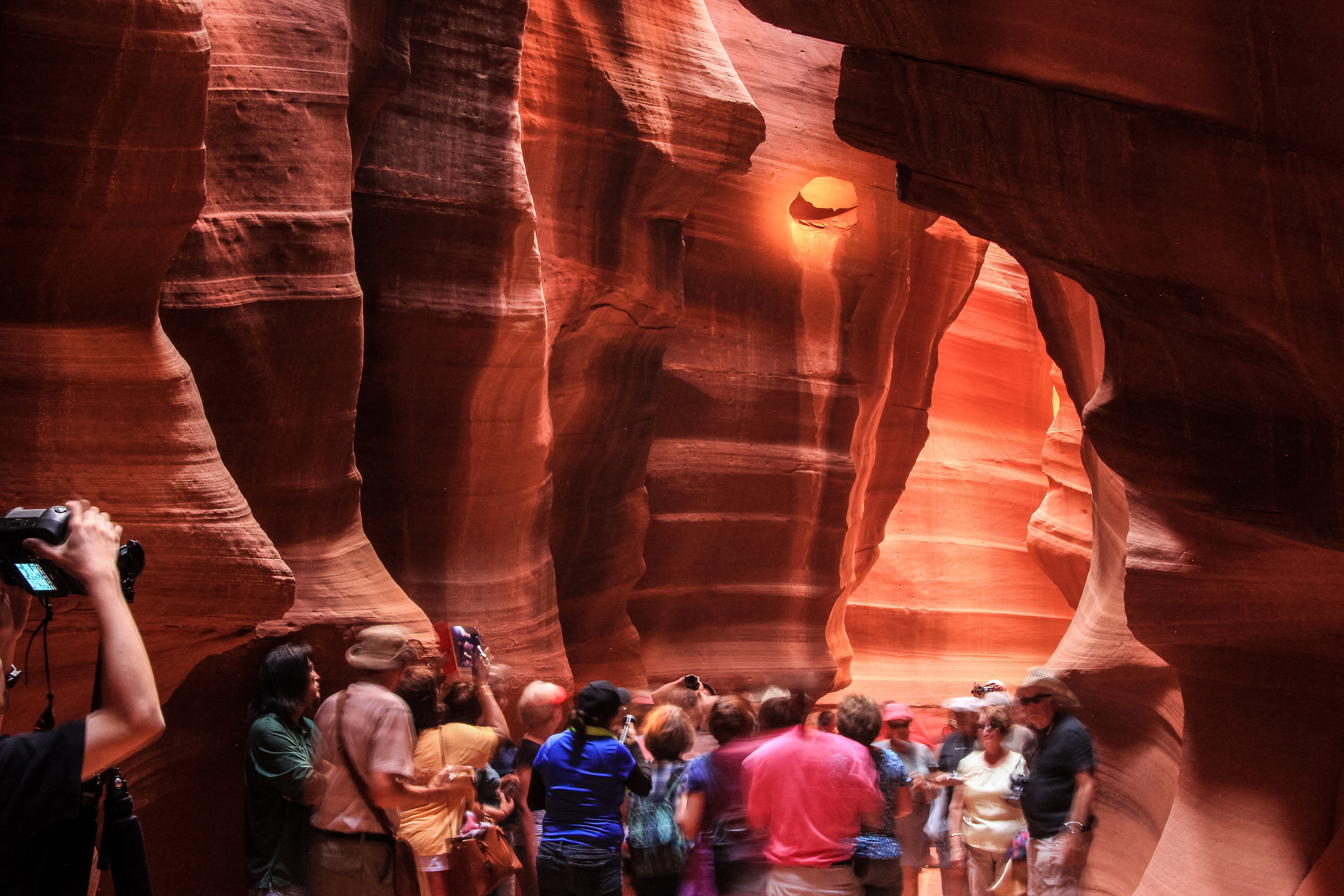 Page, AZ, USA - September 5, 2014: Tourists enjoying visit and photographing within Antelope Canyon